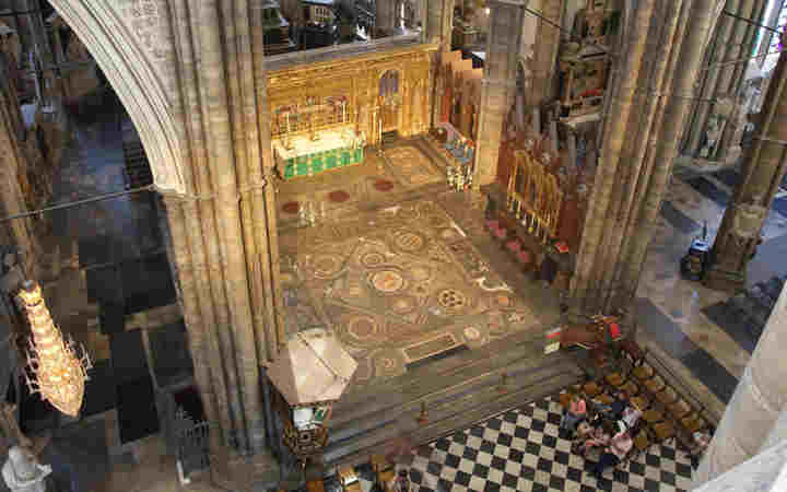 Photograph from above of the coronation theatre, including the Cosmati Pavement, the High Altar, the top of the pulpit and an area with seating.
