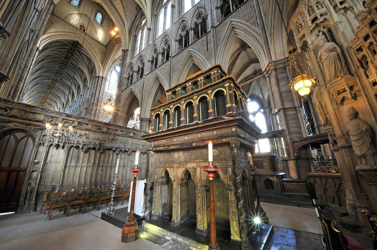 Shrine of St Edward the Confessor with large lit candles in wooden candlesticks