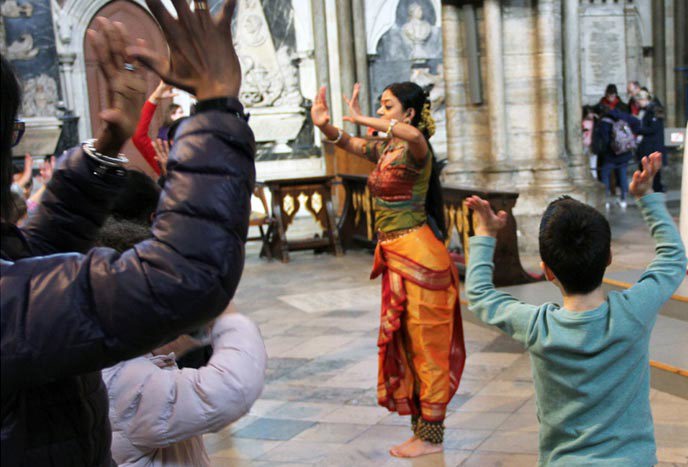 An Indian dancer demonstrates her art to children in Westminster Abbey
