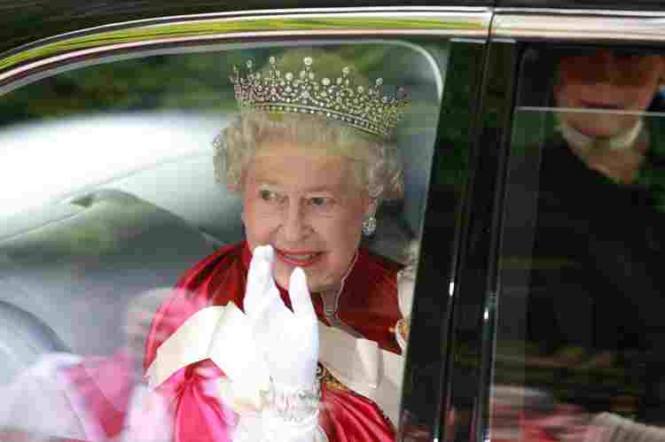 Elizabeth II wearing her red Order of the Bath robes, a tiara and white gloves