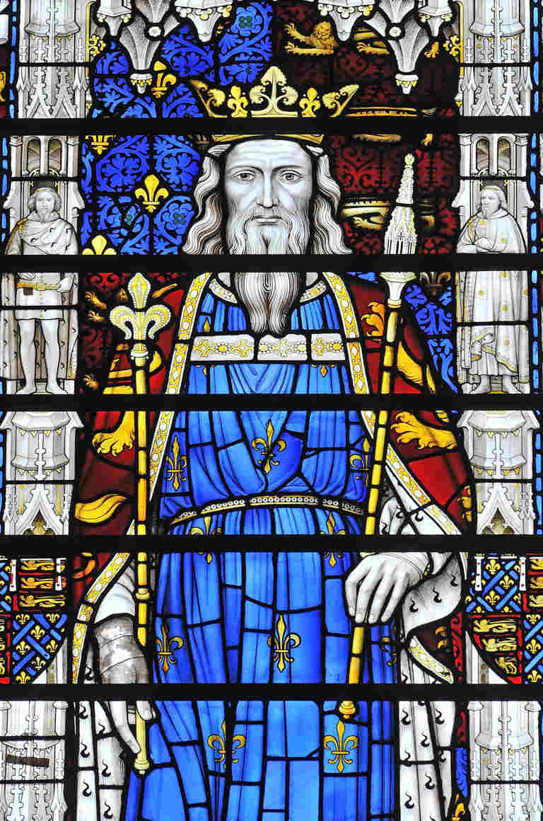 Depiction of St Edward the Confessor in stained glass, he wears a gold crown and carries two sceptres