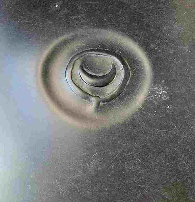 A black marble stone with the Percy family symbol of a crescent.