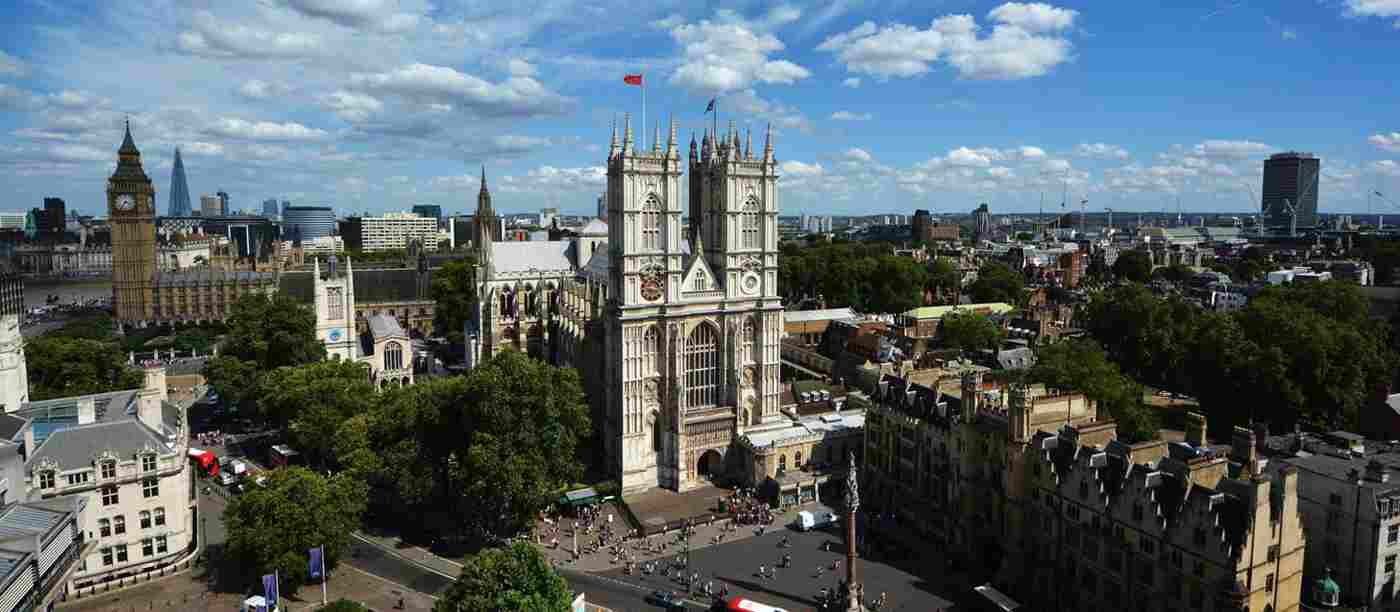 Exterior of Westminster Abbey showing the Sanctuary in the foreground and Parliament behind