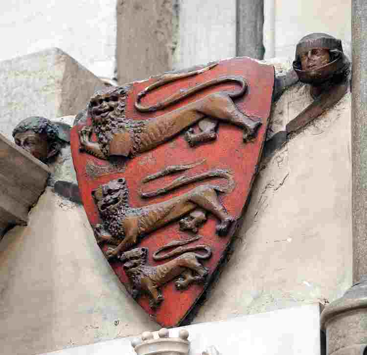 Carved shield of Henry III, three lions on a red background
