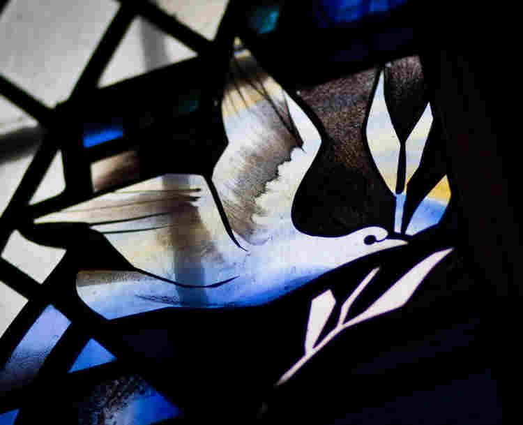 Photograph of a dove, representing the Holy Spirit, in a stained-glass window in Westminster Abbey