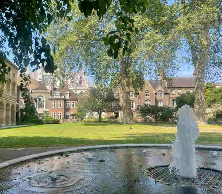 Photograph of the fountain and grass in College Garden with Westminster Abbey in the background
