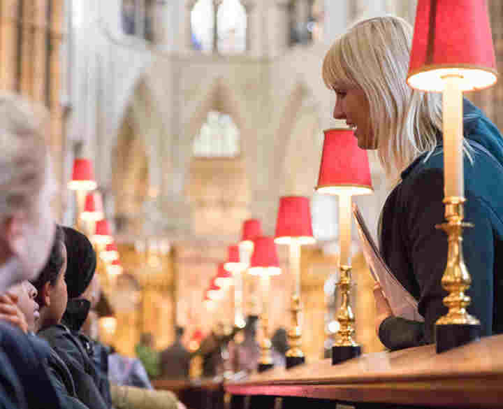 A member of the learning team takes a primary school on a guided tour of Westminster Abbey