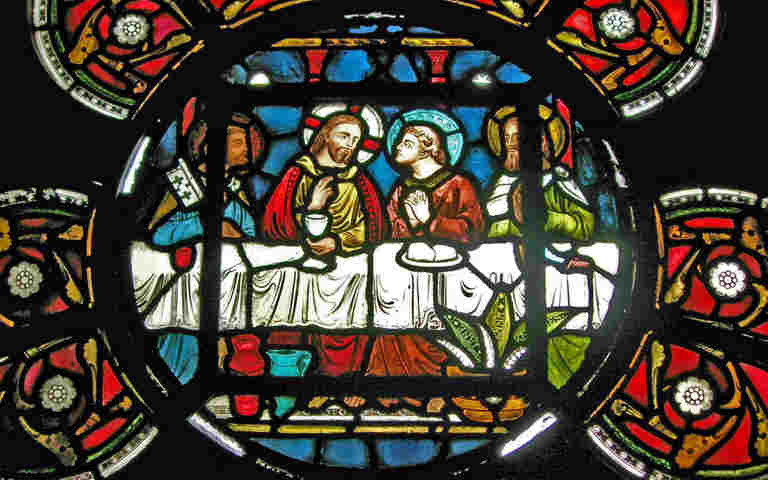 Photograph of the Last Supper within a stained-glass window in Westminster Abbey's Chapter House, representing the theme of Lent and Easter