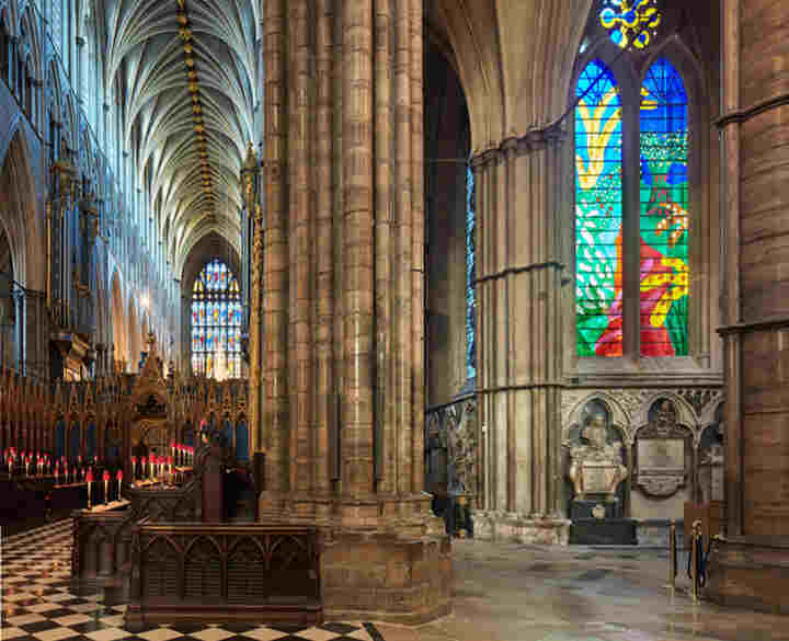 Photograph of the inside of Westminster Abbey, featuring the quire and the Queen's window
