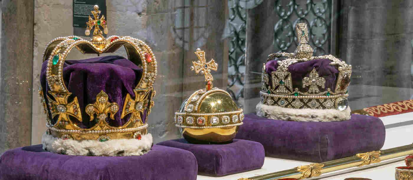 Photograph of the replica royal regalia, including two crowns, an orb and sceptres displayed in the Queen's Diamond Jubilee Galleries at Westminster Abbey