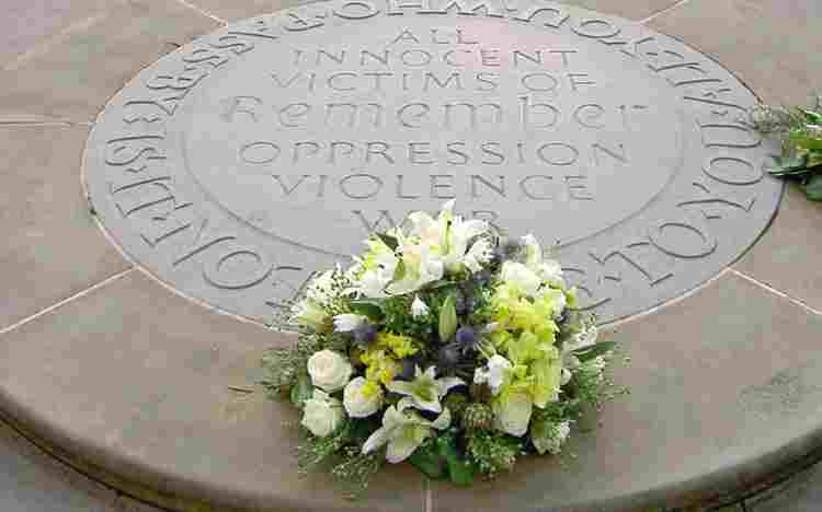 An arrangement of white flowers placed on the Innocent Victims' Memorial, Westminster Abbey