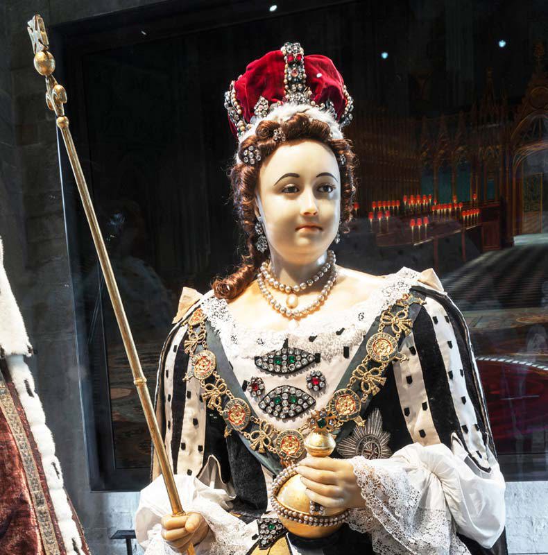 Wax effigy of Queen Anne wearing a crowing and holding a sceptre and orb