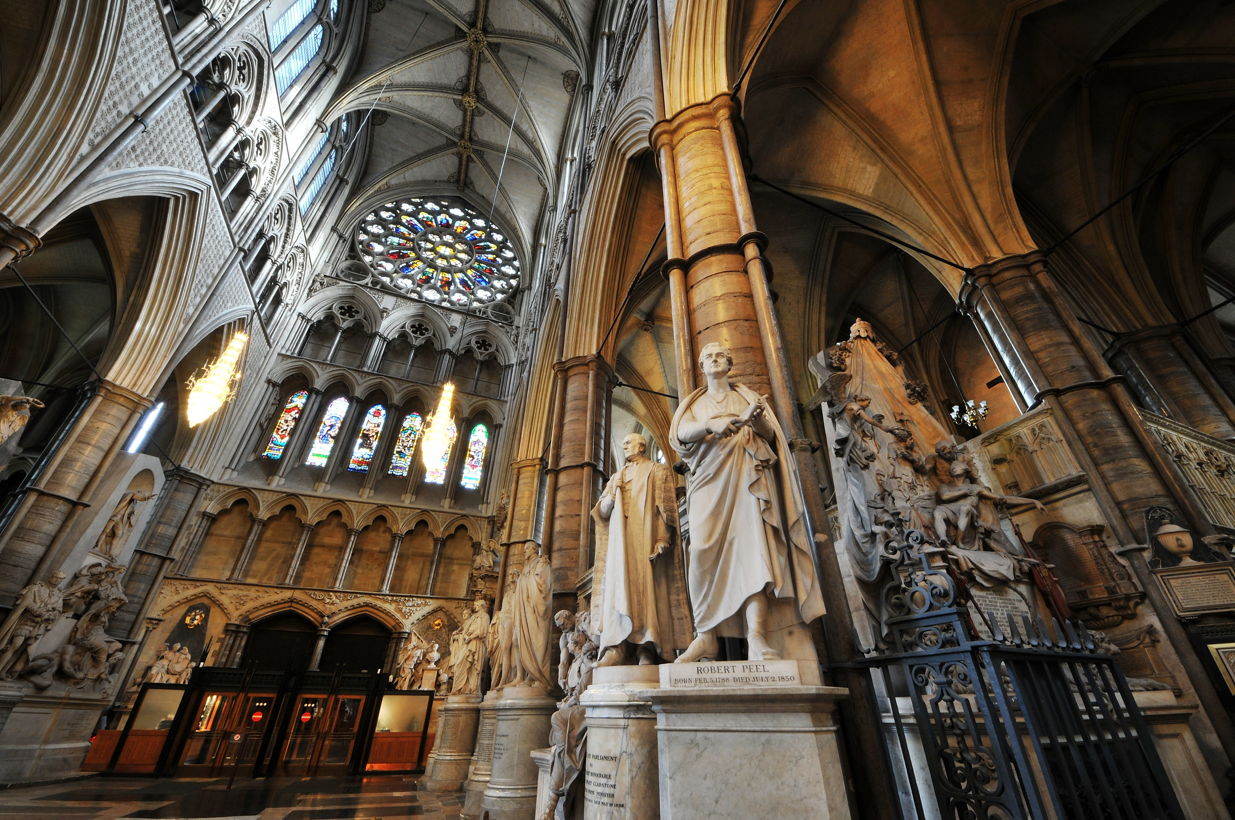 View up to the ceiling of Westminster Abbey, with marble statues and monuments in the foreground