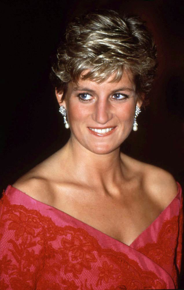 Diana, Princess of Wales, wearing a red lace and pink dress and pearl and diamond earrings