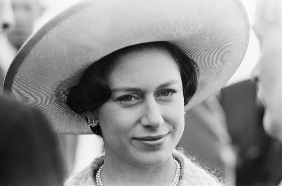 Princess Margaret in 1965 wearing a broad-brimmed hat and pearl necklace and earrings