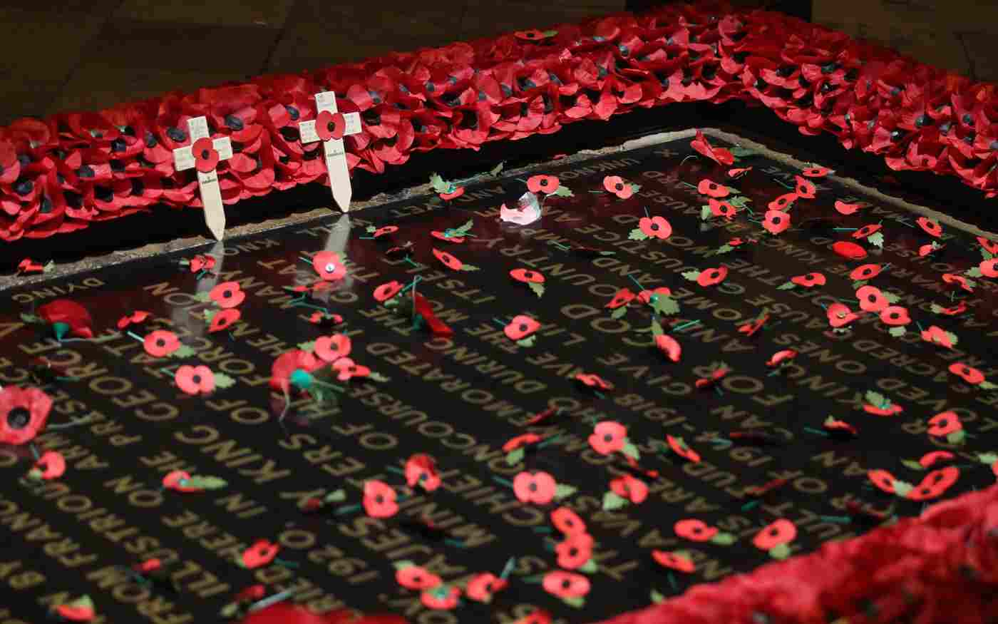 Poppies on the Grave of the Unknown Warrior. Two small crucifixes with poppies in the Centre lean on the edge