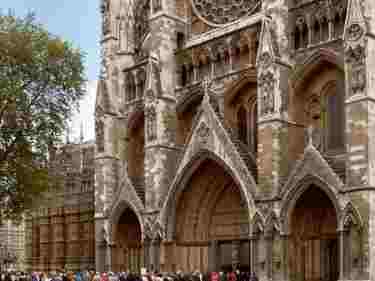 Photograph of tourists queueing to enter Westminster Abbey via the North Doors