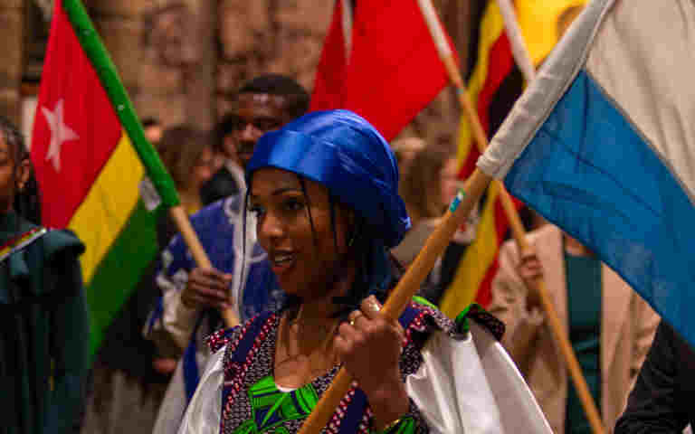 Close-up photograph of flag bearer carrying a flag during a Commonwealth service at Westminster Abbey