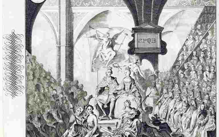 A black and white image of the coronation of King Georg II. He is sat next to the Queen Consort on the coronation chair surrounded by onlookers