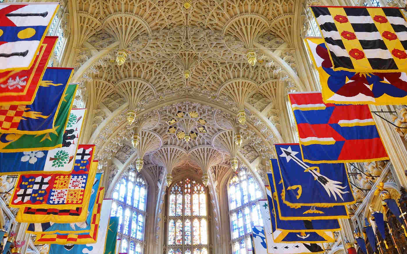 Photograph of the Lady Chapel ceiling with the colourful Order of the Bath flags for a talk by Nandini Das at Westminster Abbey