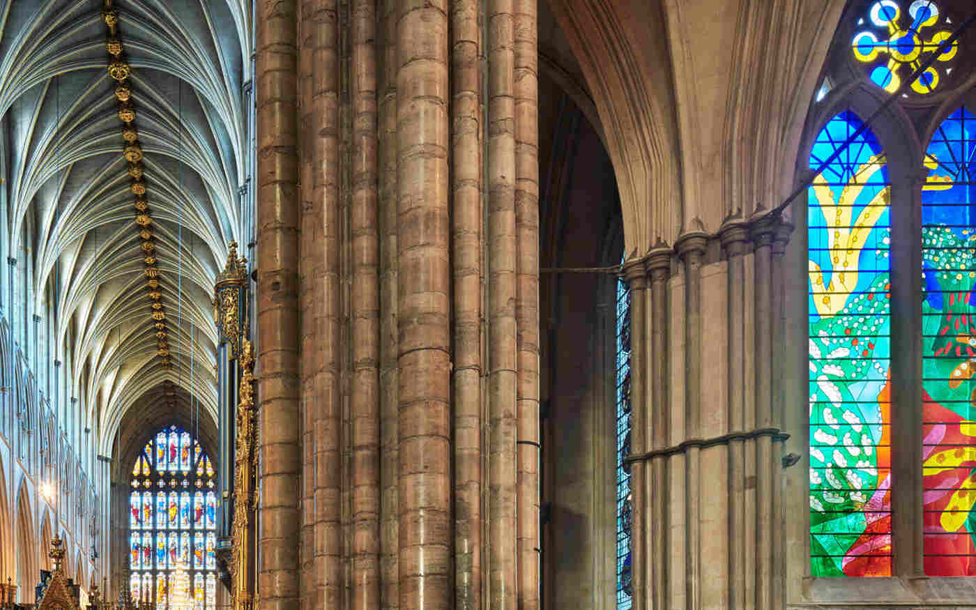 Photograph of stained glass window and gothic archtecture within the quire of Westminster Abbey