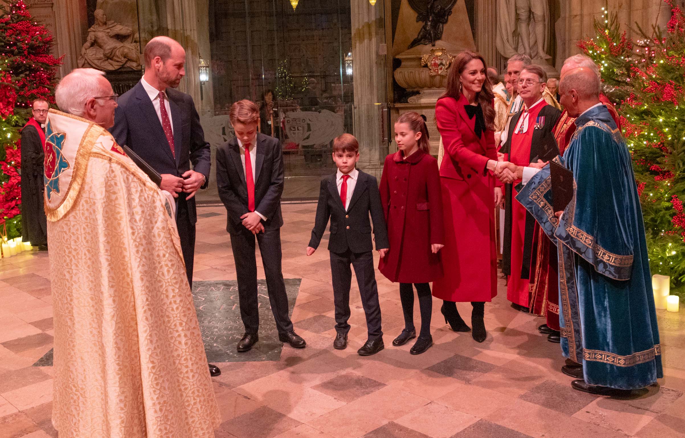 Members of clergy greet TRH The Prince and Princess of Wales and their children inside Westminster Abbe