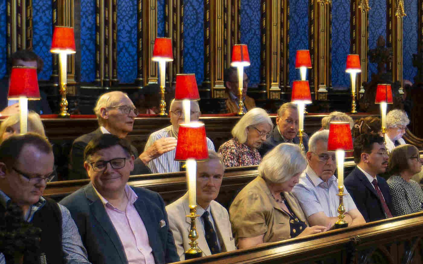 Photograph of members of the public sitting within the quire stalls of Westminster Abbey