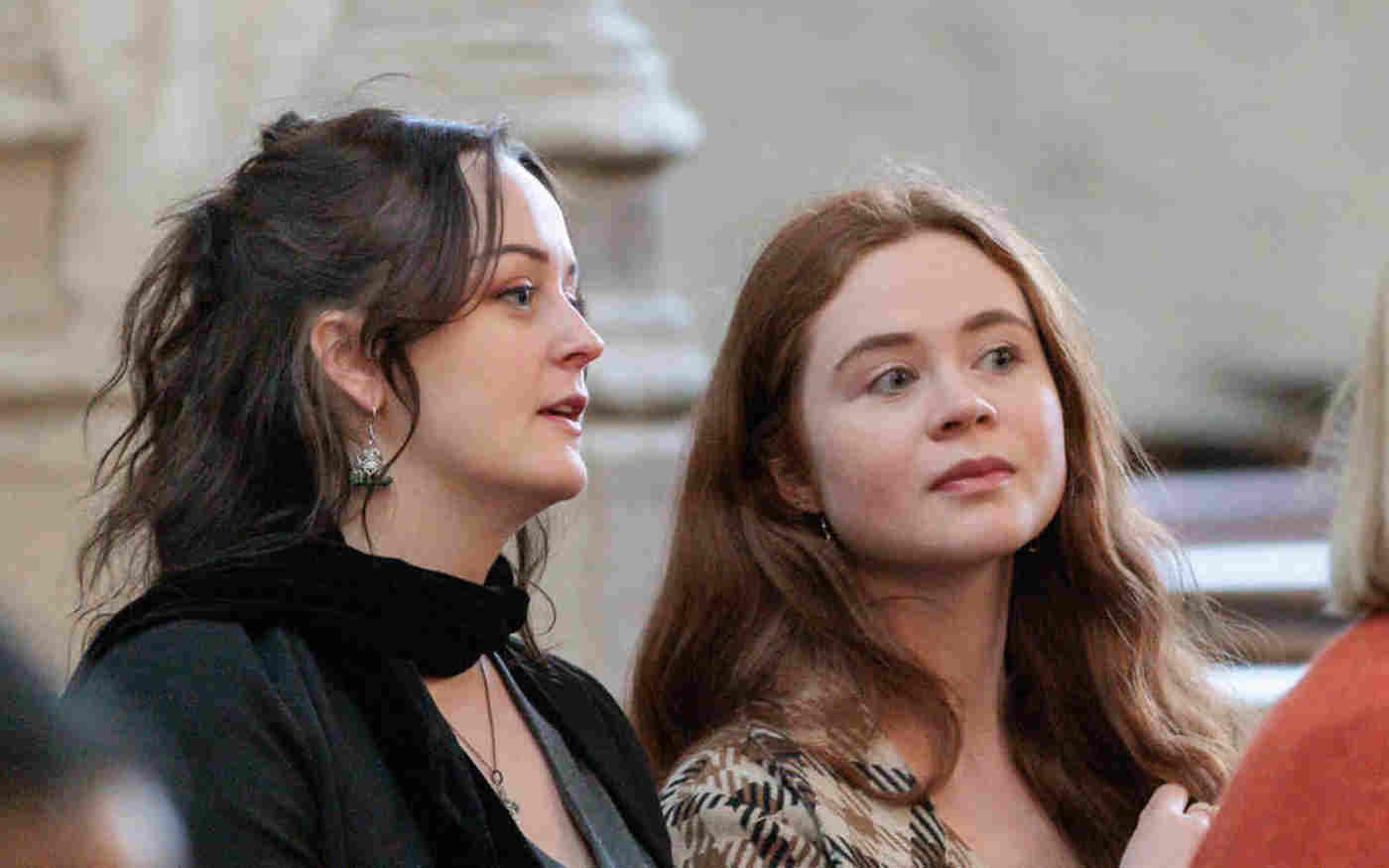 Photograph of two women sitting and listening to a talk within St Margaret's Church, Westminster Abbey