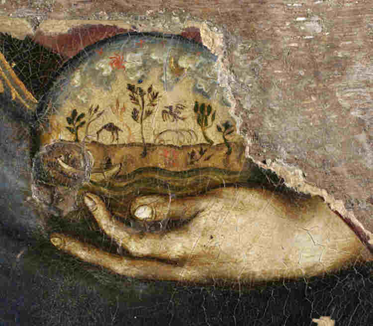 Christ's hand holding a globe of the world