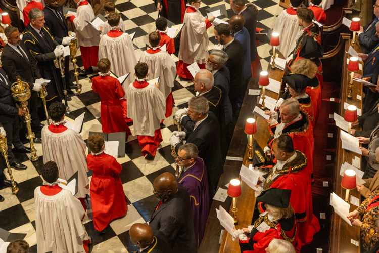 Members of the Choir of Westminster Abbey process through the church, as Mayors of the London Boroughs stand in the quire stalls