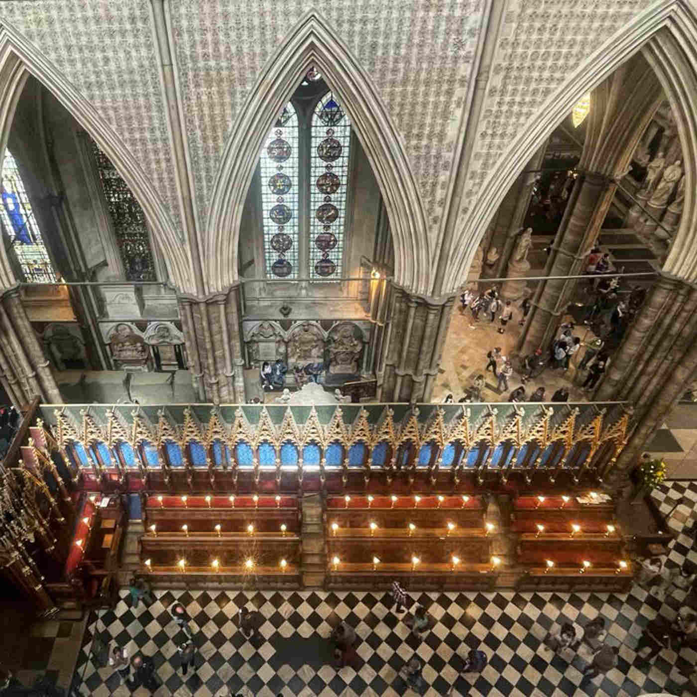 Photograph looking down onto the quire and north quire aisle, with lots of people walking around in these areas