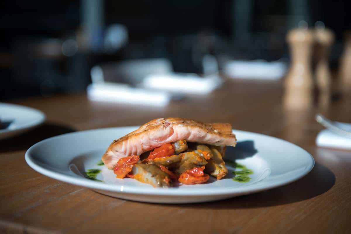 Fillet of sea bream resting on grilled artichokes, girolles and new potatoes, dressed with salsa verde