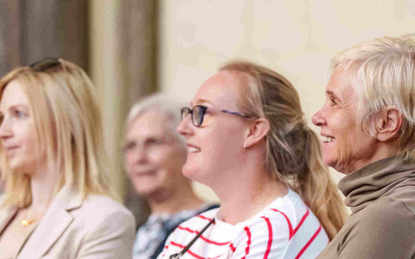 Photograph of people sitting and looking in one direction, listening to a talk at Westminster Abbey