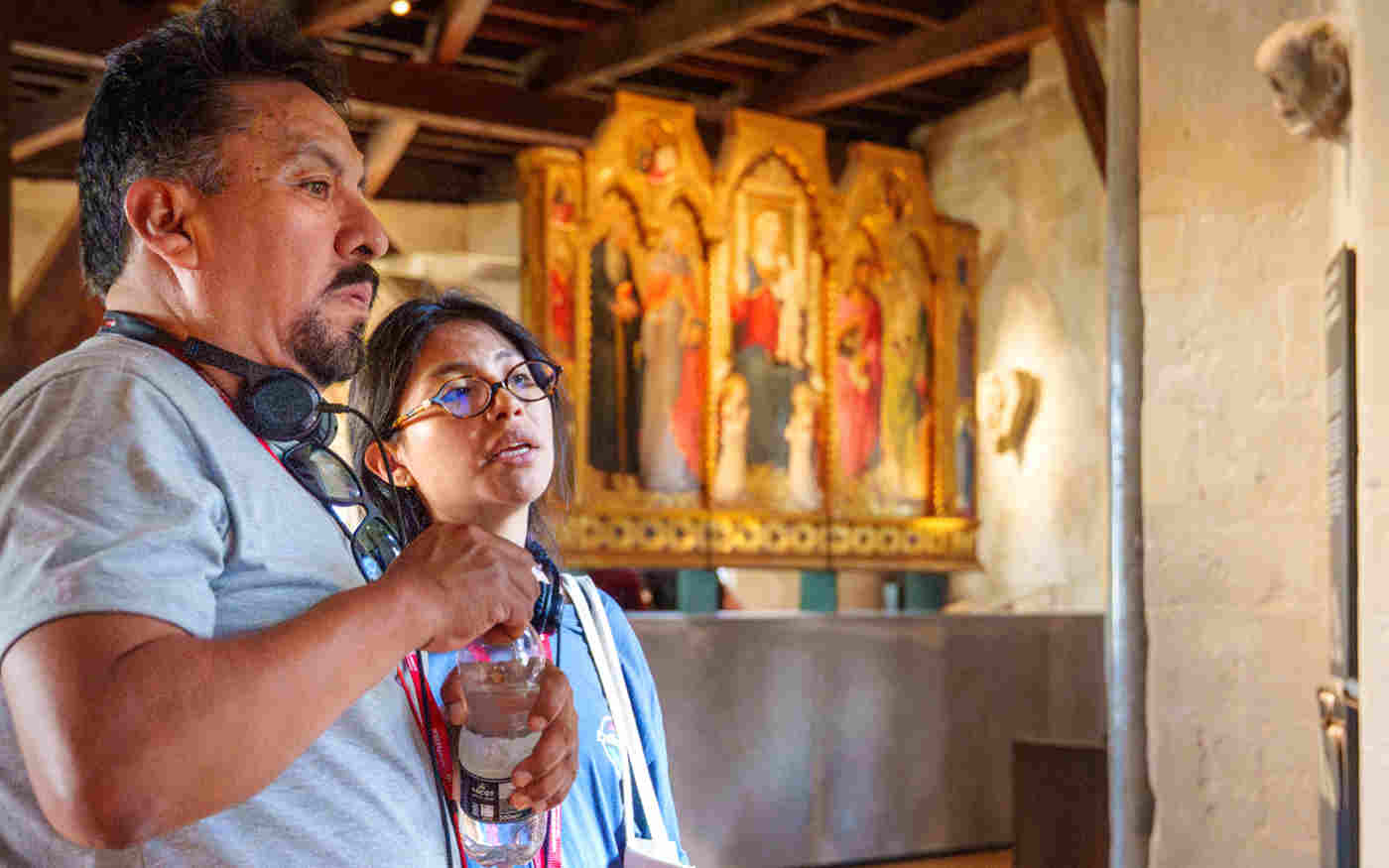 Photograph of two people looking at objects in the Queen's Diamond Jubilee Galleries at Westminster Abbey